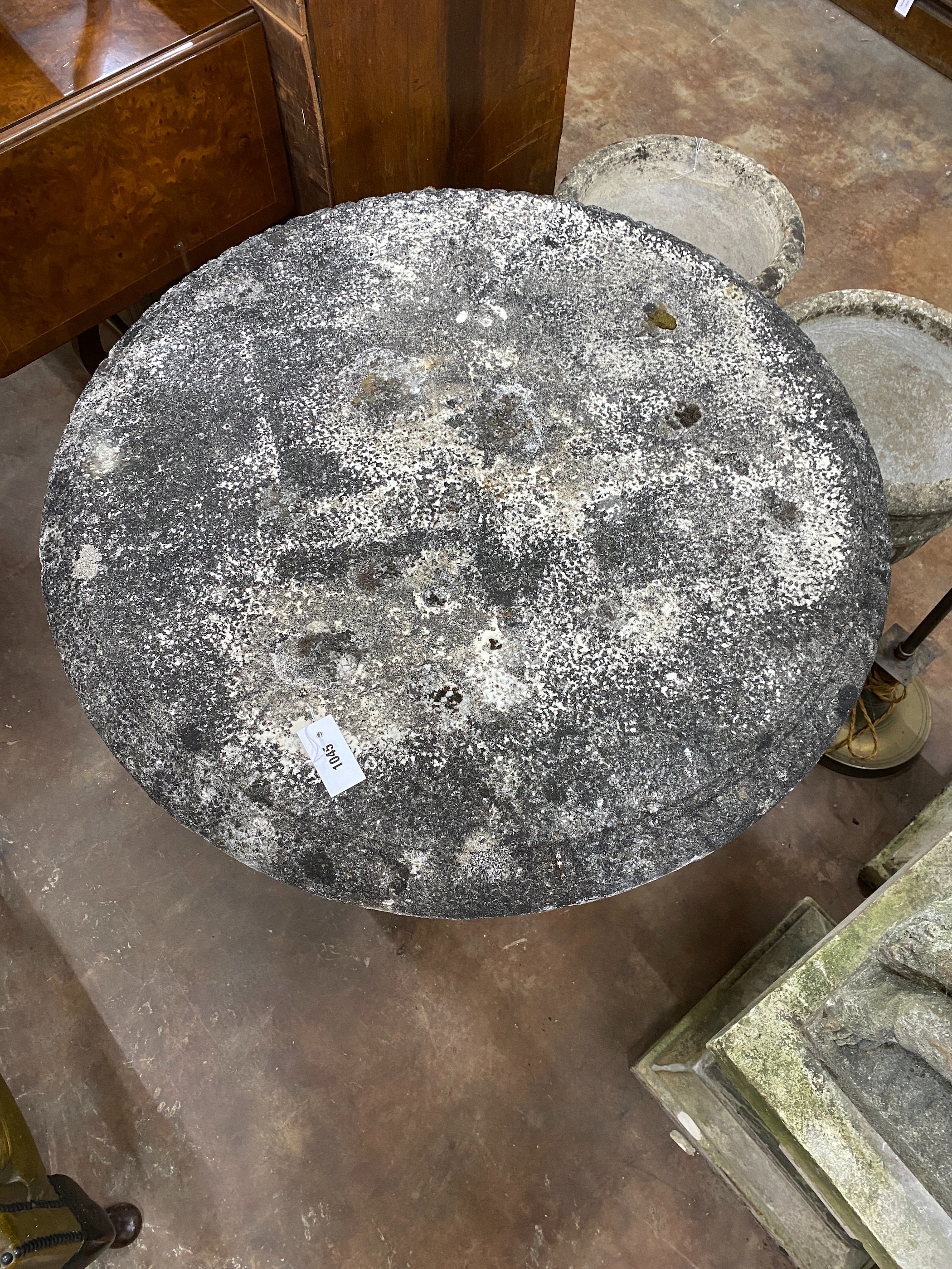 A circular reconstituted stone garden table, diameter 90cm, height 62cm